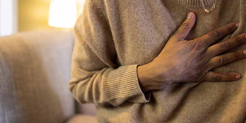 Photo of showing a close up of an adult with their hand on their chest