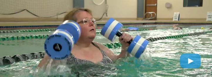 A woman exercising in a swimming pool. Clip from a video.