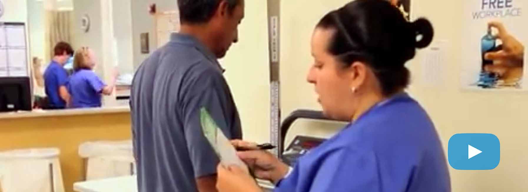 Nurse in a clinic with FIT test instructions.