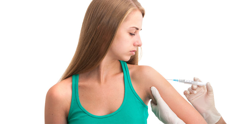 Woman getting a vaccine injected