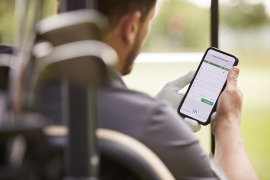 Photo of an adult male looking at his smartphone